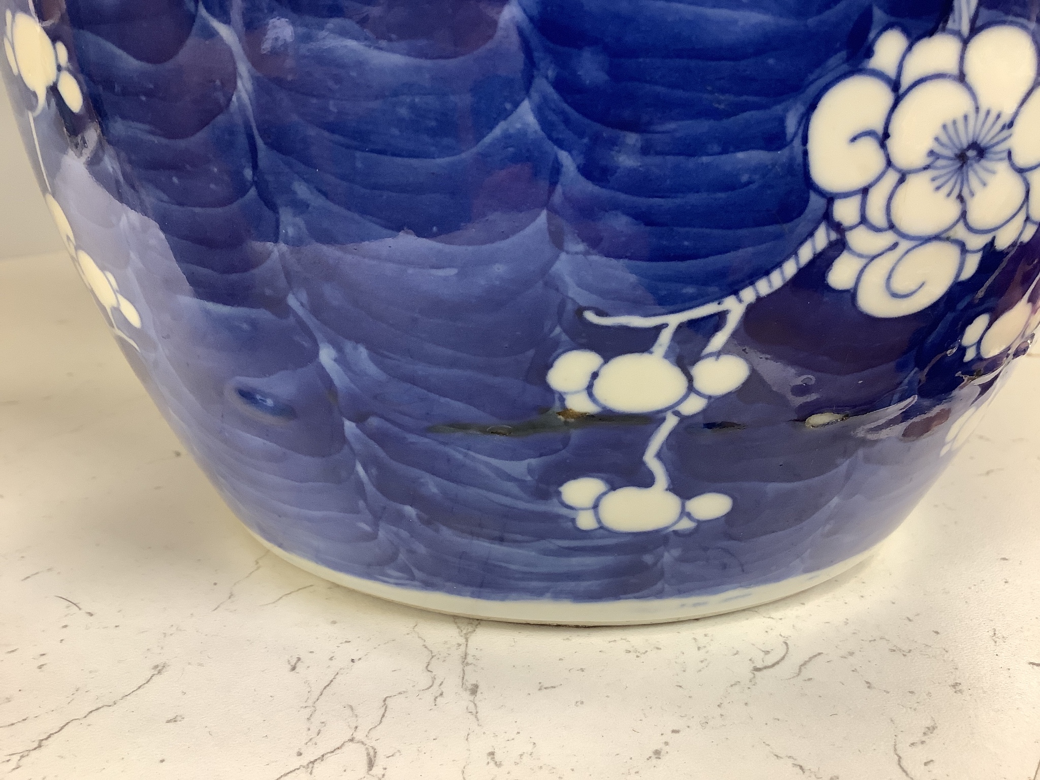 A 19th century Chinese porcelain prunus jar and cover, 27cm, on carved wood stand, a smaller famille noire jar and cover, a Chinese export fruit bowl, blue and white dish and a similar jar and cover 27cm